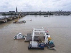 Amenée du gabion plein sous le palonnier du portique de levage et pose.